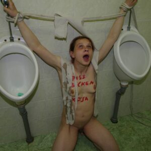 Nude German submissive woman Katja tied to urinals