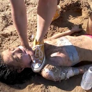 Girl throat fucked with hand and chocked with foot in the sand