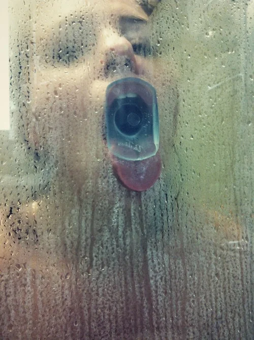 Crystal dildo deepthroat through a shower glass